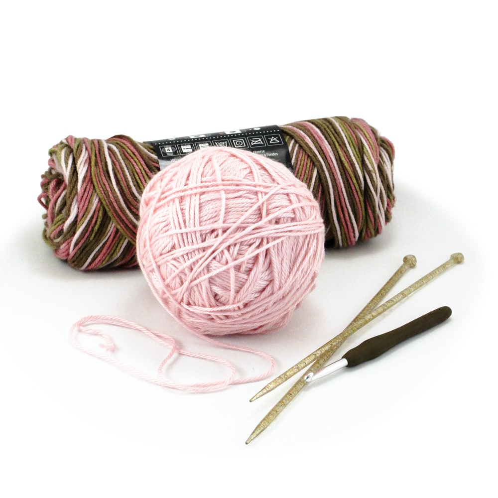 Yarn with crochet hook and knitting needles