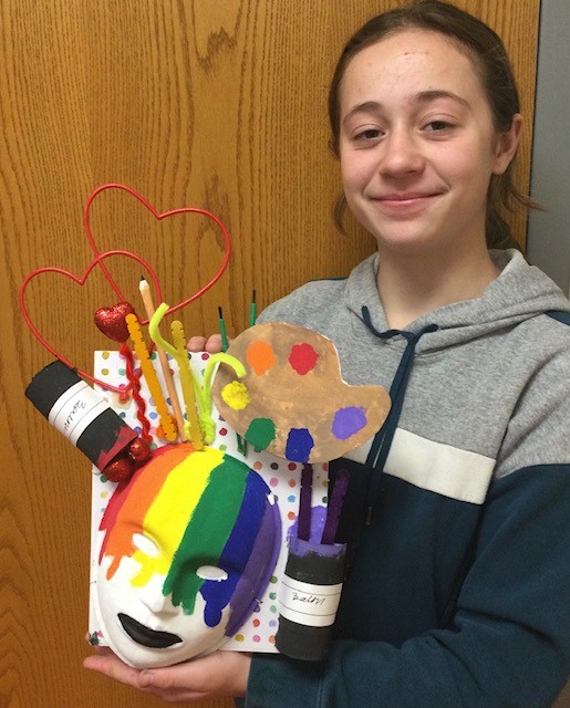 Teen girl displaying her 3-dimensional artwork