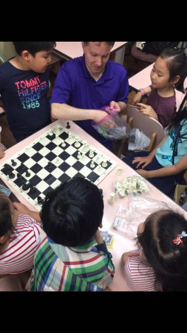 Photo of children being instructed in chess